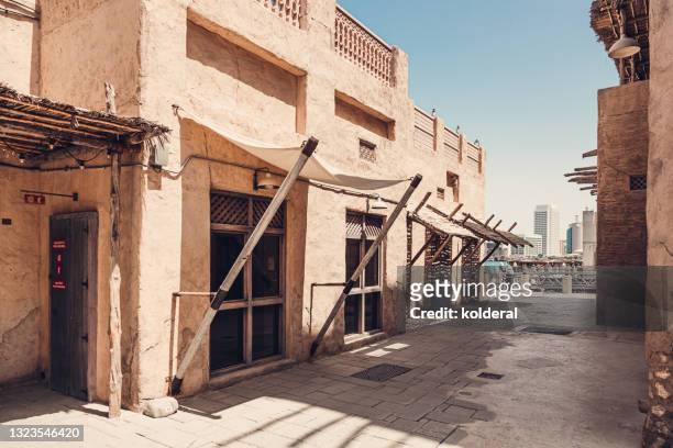 alley in historic neighborhood of dubai, traditional architecture renovated buildings - arabian peninsula stock pictures, royalty-free photos & images