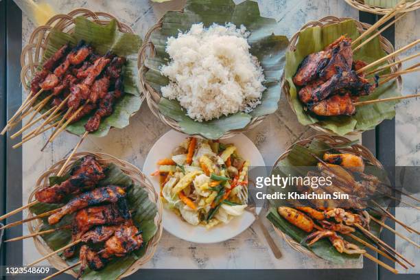 barbecue meat seafood skewers with rice and vegetables - philippines stock pictures, royalty-free photos & images
