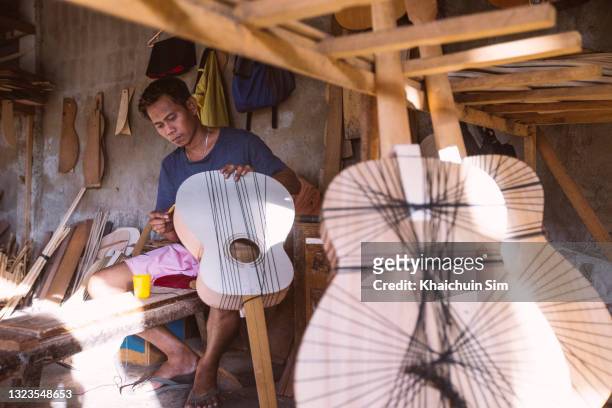handcraft guitar maker at guitar workshop - bohol philippines stock pictures, royalty-free photos & images