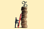 Man Leans Ladder Against Tall Stack Of Coins Topped With Interest Rate Symbol