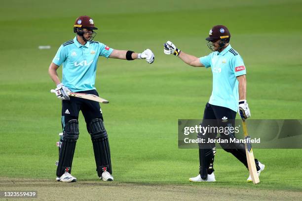 Laurie Evans and Jamie Smith of Surrey punch gloves during the Vitality T20 Blast match between Surrey and Glamorgan at The Kia Oval on June 14, 2021...