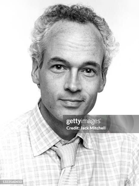 Portrait of playwright Jonathan Reynolds in front of a white background, July 1981.