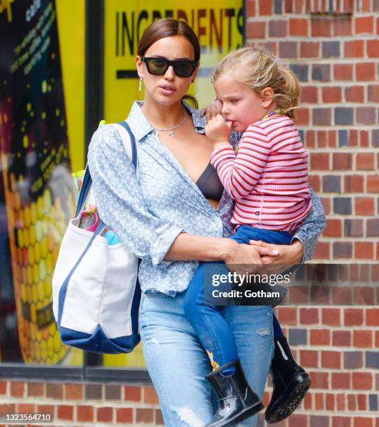 Irina Shayk carries Lea de Seine while on a stroll on June 14, 2021 in New York City.