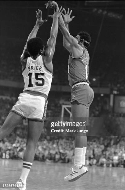 Portland Trail Blazers guard Lionel Hollins takes a jump shot over Denver Nuggets guard Jim Price during an NBA basketball game at McNichols Arena on...