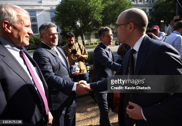 New York Times Publisher A.G. Sulzberger shakes hands with CNN Executive Vice President David Vigilante as New York Times lawyer David McCraw looks...