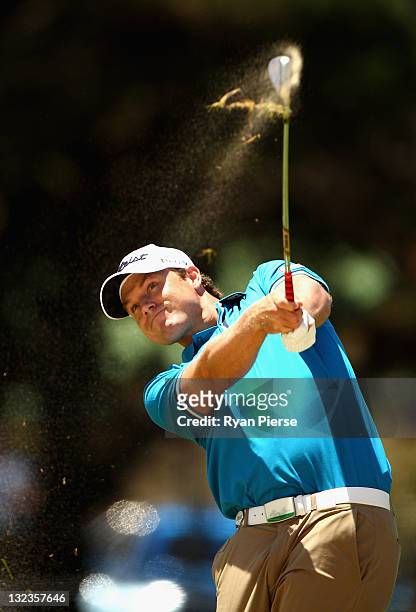 Nick Watney of the USA hits his second shot on the 4th Hole during day three of the 2011 Emirates Australian Open at The Lakes Golf Club on November...