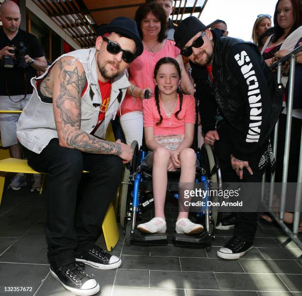 Good Charlotte's Joel Madden and Benji Madden pose alongside Candace Murphy and her mother Maryanne Murphy collect donations on behalf of McHappy...