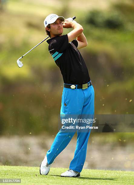 Rohan Blizard of Australia hits his second shot on the 1st Hole during day three of the 2011 Emirates Australian Open at The Lakes Golf Club on...