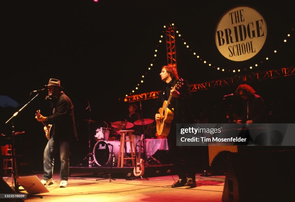 Neil Young performs with Peter Buck of R.E.M. during Neil Young's