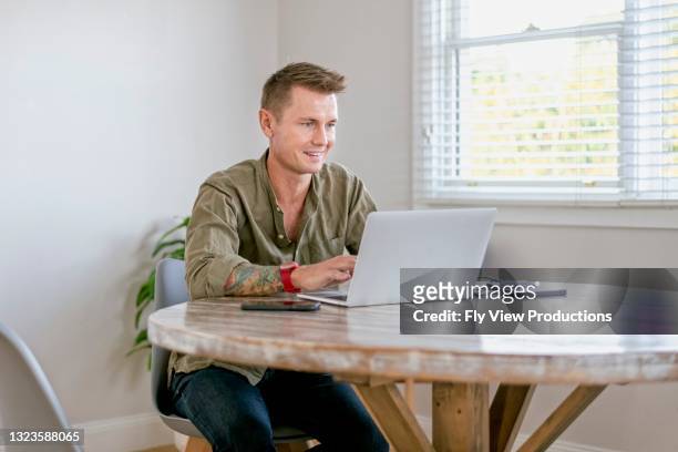 attractive male works from home - ordinary guy stock pictures, royalty-free photos & images