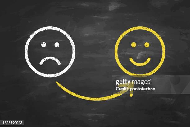 drawing unhappy and happy solution concepts on blackboard background - positive emotion stock illustrations