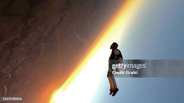 a parachutist in free fall at the sunset. - skydiving bildbanksfoton och bilder