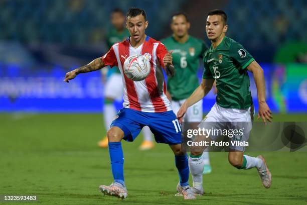 Alejandro Romero Gamarra of Paraguay competes for the ball with Boris Cespedes of Bolivia during a Group A match between Paraguay and Bolivia at...