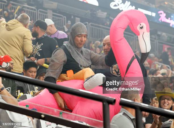 https://media.gettyimages.com/id/1323593502/photo/las-vegas-nevada-a-fan-wearing-a-knight-outfit-and-an-inflatable-pink-flamingo-arrives-at.jpg?s=612x612&w=gi&k=20&c=m-rupJ28erJraNfRe-bDLZBtOfGoIYOF0iHOJXMmKSo=