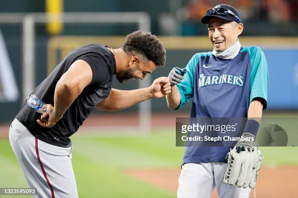 Nelson Cruz of the Minnesota Twins shares in a moment with Ichiro Suzuki of the Seattle Mariners before the game at T-Mobile Park on June 14, 2021 in...