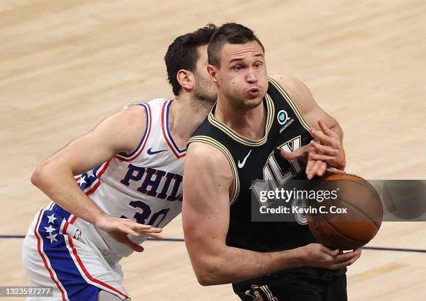 Danilo Gallinari of the Atlanta Hawks loses the ball as he is defended by Furkan Korkmaz of the Philadelphia 76ers during the second half of game 4...