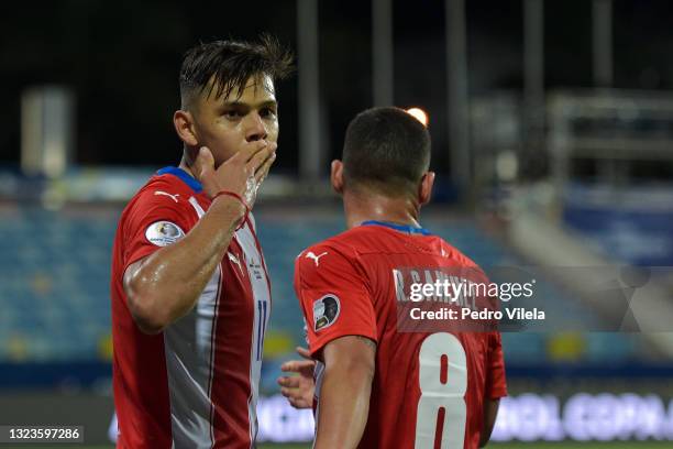 Angel Romero of Paraguay celebrates with teammate Richard Sanchez after scoring the second goal of his team during a Group A match between Paraguay...