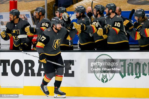 Shea Theodore of the Vegas Golden Knights is congratulated by his teammates after scoring a goal against the Montreal Canadiens during the first...