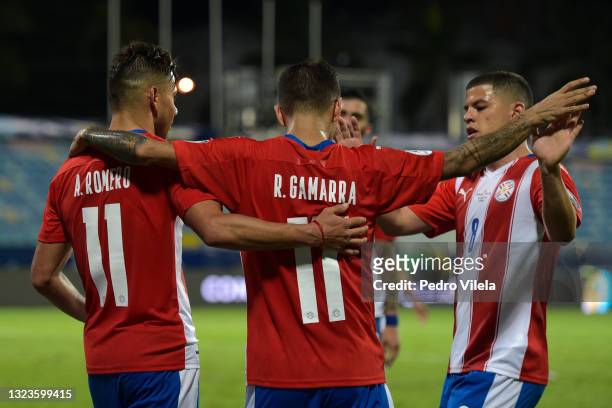 Angel Romero of Paraguay celebrates with teammates Alejandro Romero Gamarra and Richard Sanchez after scoring the third goal of his team during a...