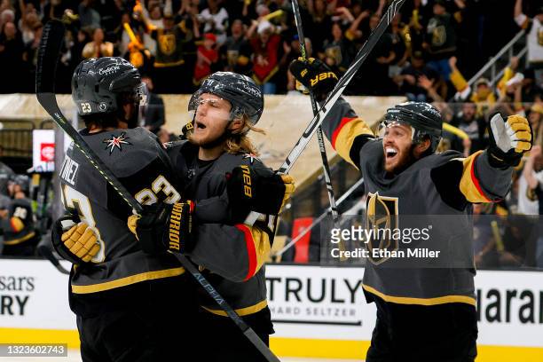 Alec Martinez of the Vegas Golden Knights is congratulated by William Karlsson and Jonathan Marchessault after scoring a goal against the Montreal...