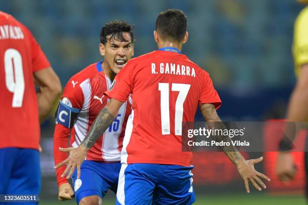 Alejandro Romero Gamarra of Paraguay celebrates with teammate Gustavo Gomez after scoring the first goal of his team during a Group A match between...