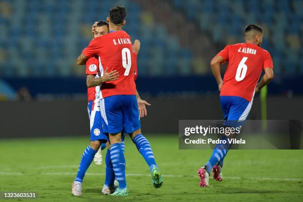 Alejandro Romero Gamarra of Paraguay celebrates with teammate Gabriel Avalos after scoring the first goal of his team during a Group A match between...