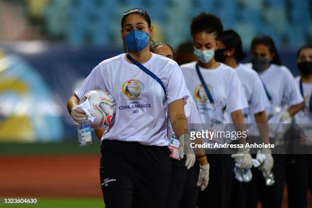 Ball girls wearing face masks hold hand sanitizers before a Group A match between Paraguay and Bolivia at Estádio Olímpico as part of Copa America...