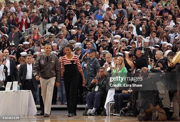 President Barack Obama and first lady Michelle Obama arrive for the NCAA men's college basketball Carrier Classic between the Michigan State Spartans...