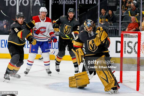 Marc-Andre Fleury of the Vegas Golden Knights makes a glove save as Zach Whitecloud of the Golden Knights, Corey Perry of the Montreal Canadiens and...