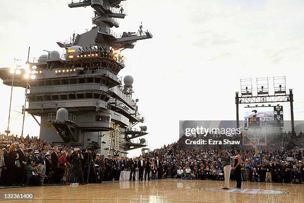 President Barack Obama and first lady Michelle Obama speak to the crowd before the start of the NCAA men's college basketball Carrier Classic between...