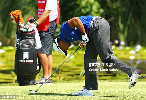 Tiger Woods of the USA reacts after a shot on the eighth hole during day three of the 2011 Emirates Australian Open at The Lakes Golf Club on...