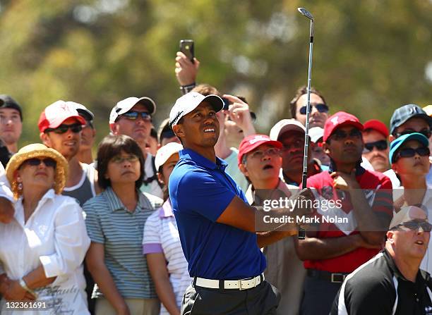 Tiger Woods of the USA chips out of trouble on the eighth hole during day three of the 2011 Emirates Australian Open at The Lakes Golf Club on...