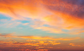 Beautiful glowing pink and golden cirrus clouds after storm at sunset, colorful dramatic sunset cloudscape, soft sunlight