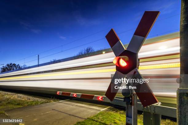 railroad crossing with fast train - weichen gleise stock-fotos und bilder