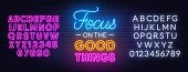Focus on the Good Things neon lettering on brick wall background.