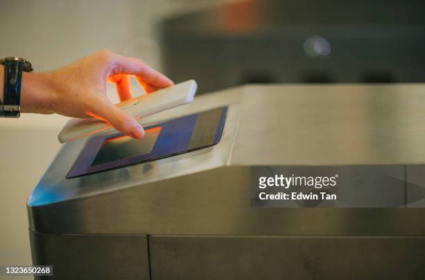 waiting in line e-ticketing asian chinese man hand using smart phone mobile app barcode scanning at movie theater entrance - sport venue stock pictures, royalty-free photos & images