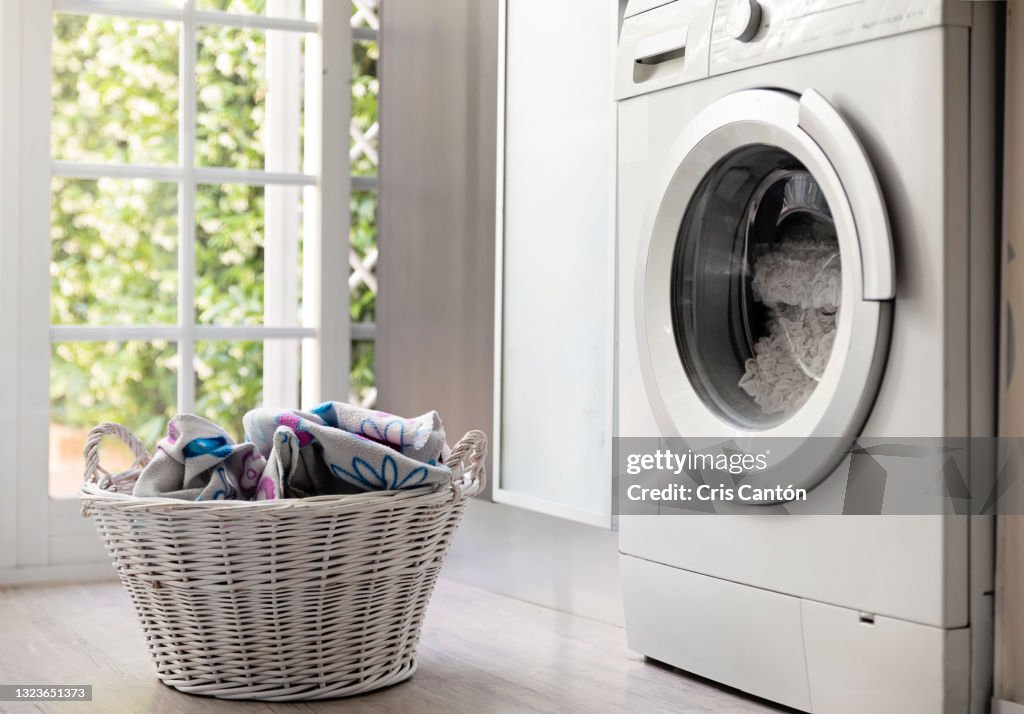 Laundry room with washing machine and laundry basket