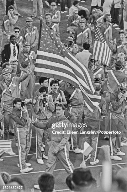 American hammer thrower Ed Burke carries the flag of the United States in his role as flag-bearer for the US Olympic team during the 1984 Summer...