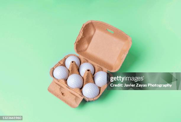 golf balls in recycled paper carton for eggs on green background - golf gifts stock pictures, royalty-free photos & images