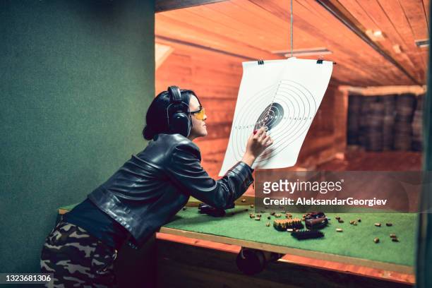 female shooting competitor marking shooting results on target - gun safety stock pictures, royalty-free photos & images