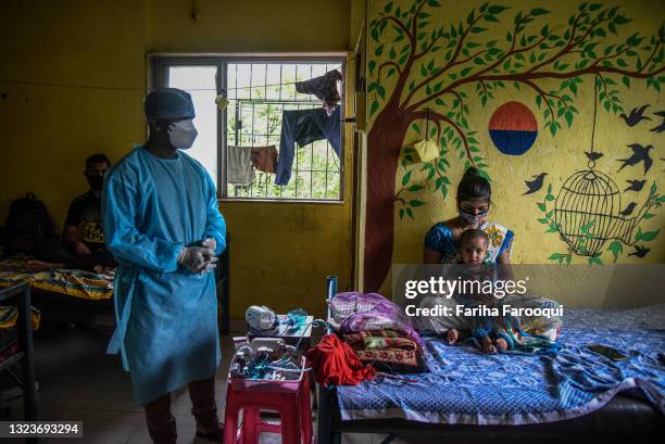 Pradip Salave Shramajeevi, a healthcare worker, checks on his patients inside a school which has been converted into a Covid-19 care facility on June...