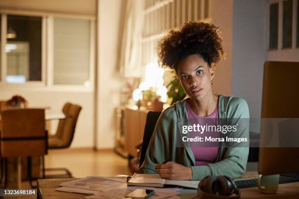 young freelancer working late at home office - staring stock pictures, royalty-free photos & images