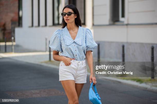 Alyssa Cordes is seen wearing white shorts Levis, blue checkered top Envii, Adidas sneaker, Prada bag in blue, sunglasses Mango on June 14, 2021 in...
