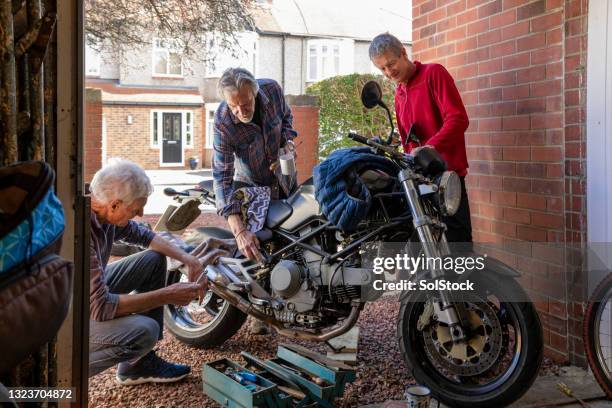 fixing the bike together - old garage at home stock pictures, royalty-free photos & images