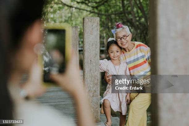 grandmother and her niece look at camera and smile in mangrove forest - stock photo - tourist mother father child thailand stock pictures, royalty-free photos & images