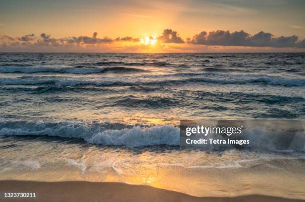 usa, florida, boca raton, sea waves and clouds at sunrise - boca raton florida stock pictures, royalty-free photos & images