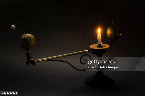 antique globe and candle solar system model - tellurium stock pictures, royalty-free photos & images
