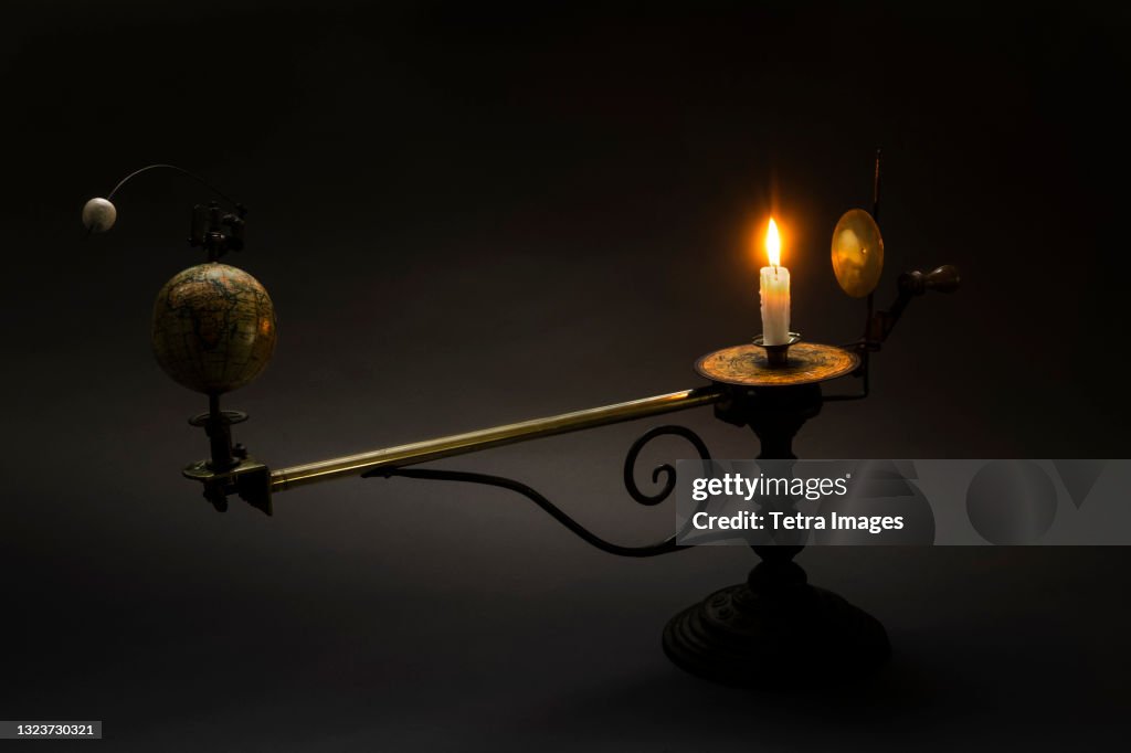 Antique globe and candle solar system model