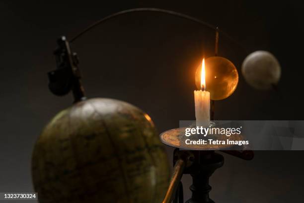 antique globe and candle solar system model - tellurium stock pictures, royalty-free photos & images