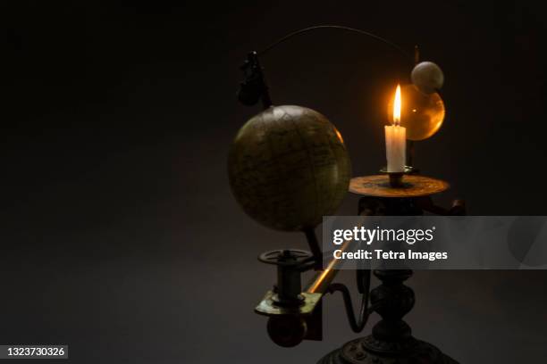 antique globe and candle solar system model - tellurium stock pictures, royalty-free photos & images